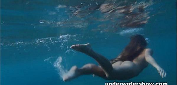  Julia is swimming underwater nude in the sea